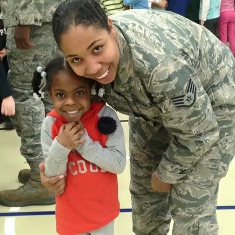 An Airman sharing a warm moment with a child at a community event